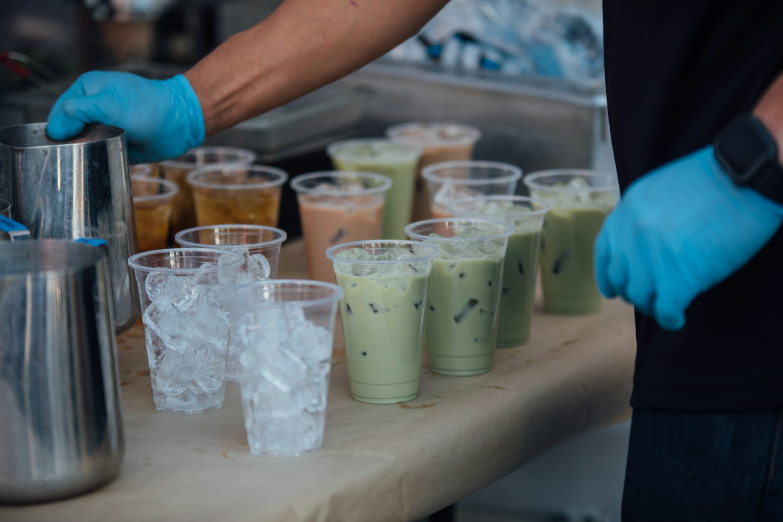 ultiple bubble tea cups lined up and ready for preparation at a vendor booth during the 2025 Canada Bubble Tea Festival in Burnaby.