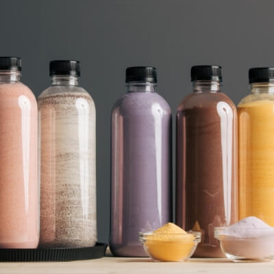 Assorted bubble tea powders including taro, chocolate, coffee, fruit, and matcha – customizable for beverages and desserts